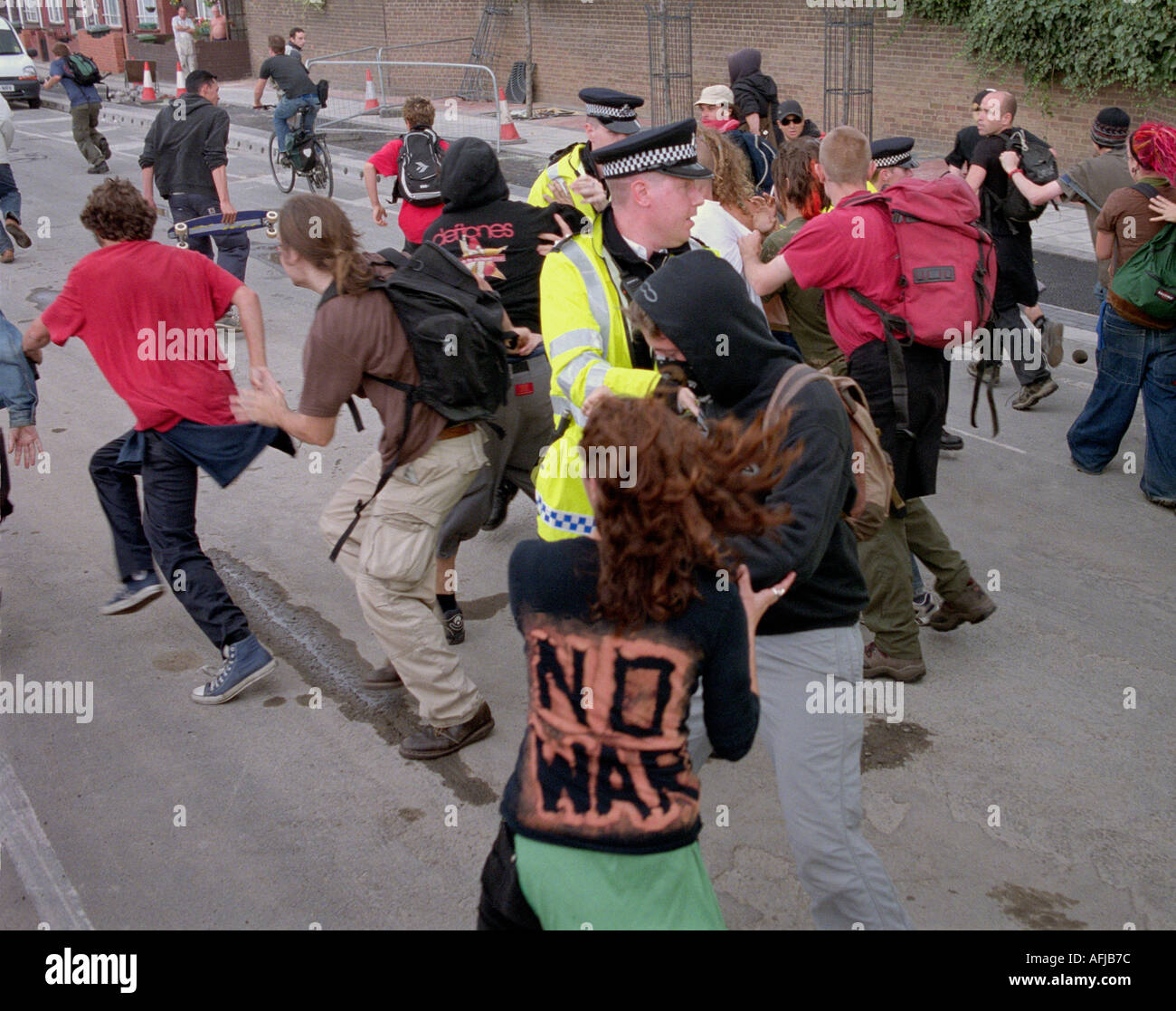 Young activists protesting against arms trade fair at the Excel Centre in London being chased by police. Stock Photo