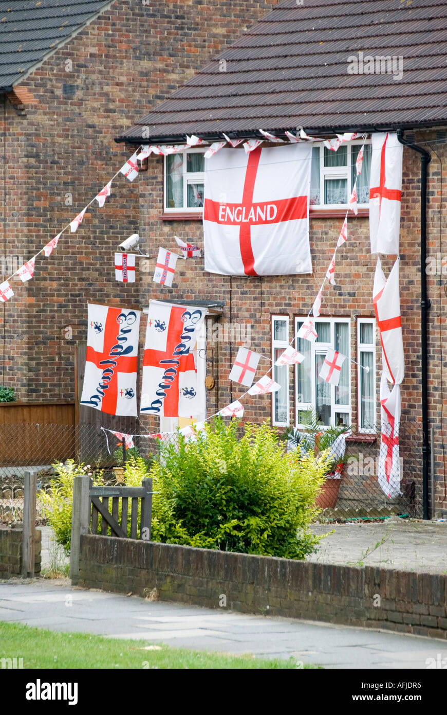 Romford house decorated in St Georges cross flags and bunting at time of international football tournament Stock Photo