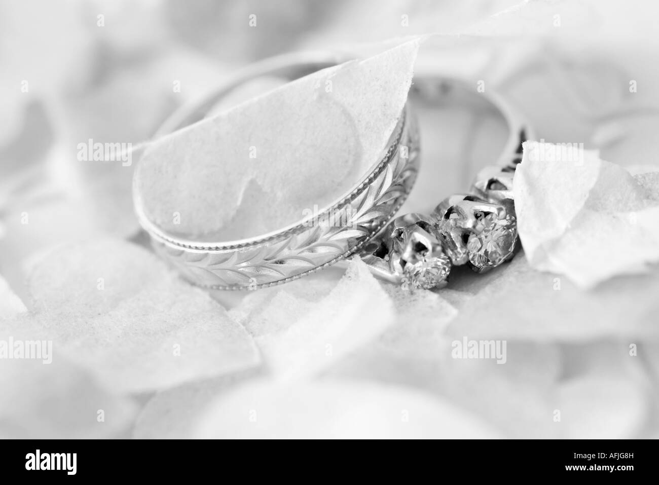 wedding ring and engagement ring surrounded by confetti Stock Photo Alamy