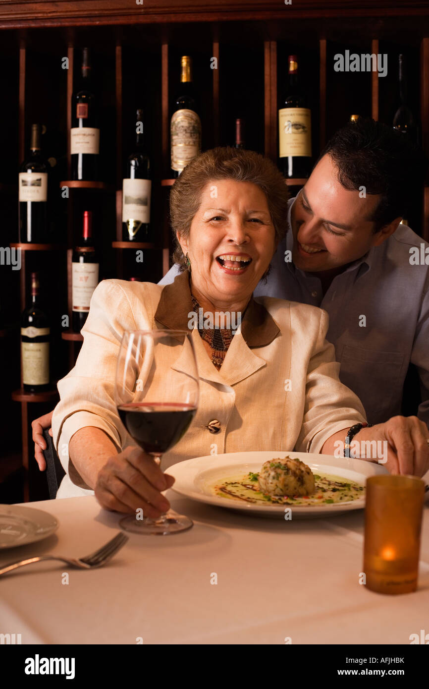 Adult son and mother dining in restaurant. Stock Photo