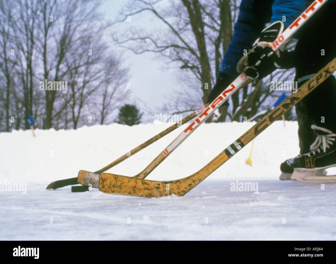 Hockey players going after a puck Stock Photo Alamy
