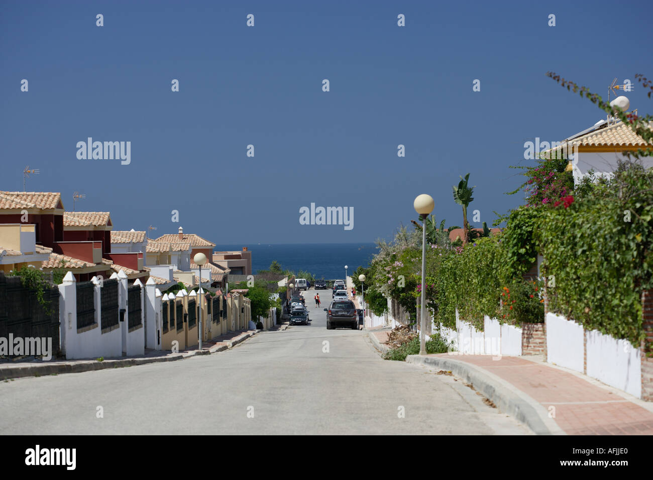 street of Spanish holiday villas leading to the sea Stock Photo