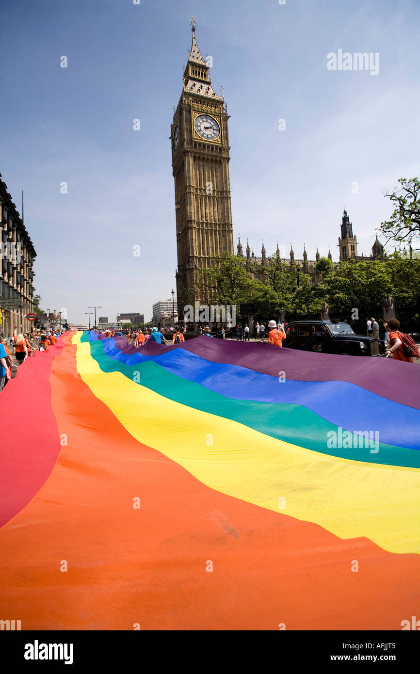 A giant rainbow flag is passing by the British Parliament during the gay parade of the EuroPride London Stock Photo