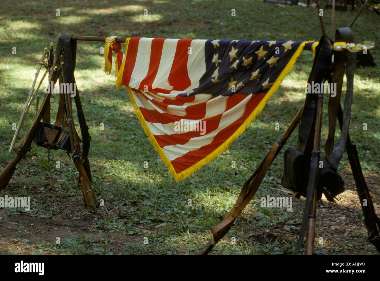 civil war reenactor Gettysburg PA battle field stacked rifles muskets flag Stock Photo