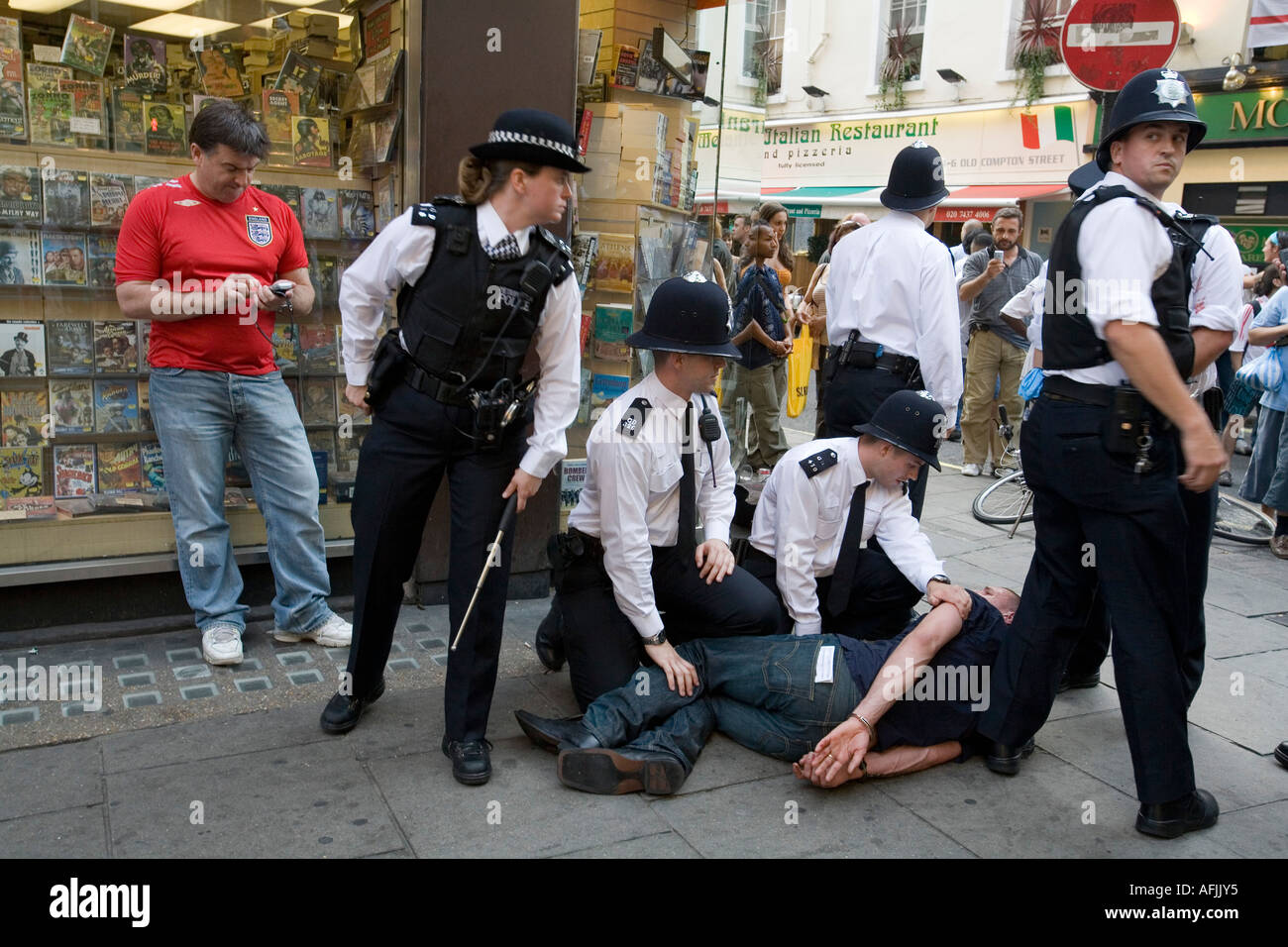 Police officers making an arrest London England Britain UK Stock Photo