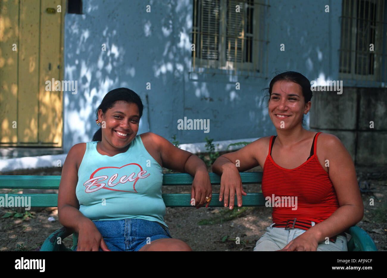 Two friendly Cuban women sitting on a bench Santiago de Cuba Cuba Stock