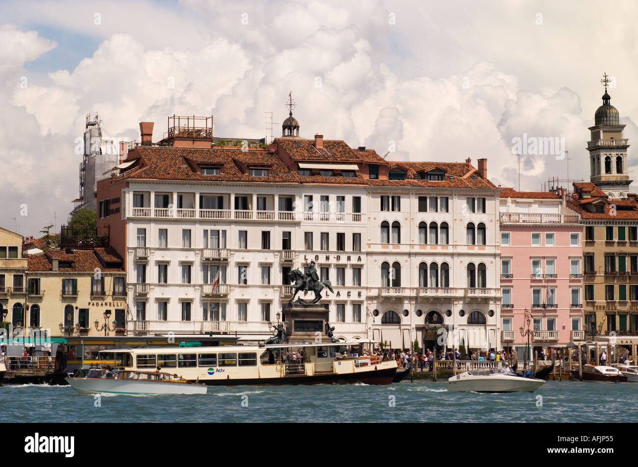 Londar Palace Hotel along the along the Riva Degli Schiavoni waterfront in Venice Italy with a water ferry in the foreground Stock Photo