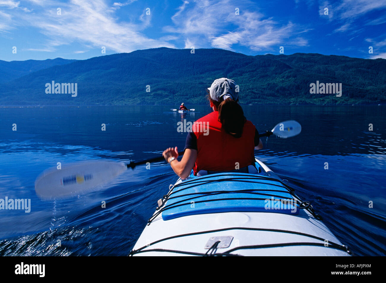 Sea kayaking in Johnstone Strait, Vancouver Island in the background, British Columbia Stock Photo
