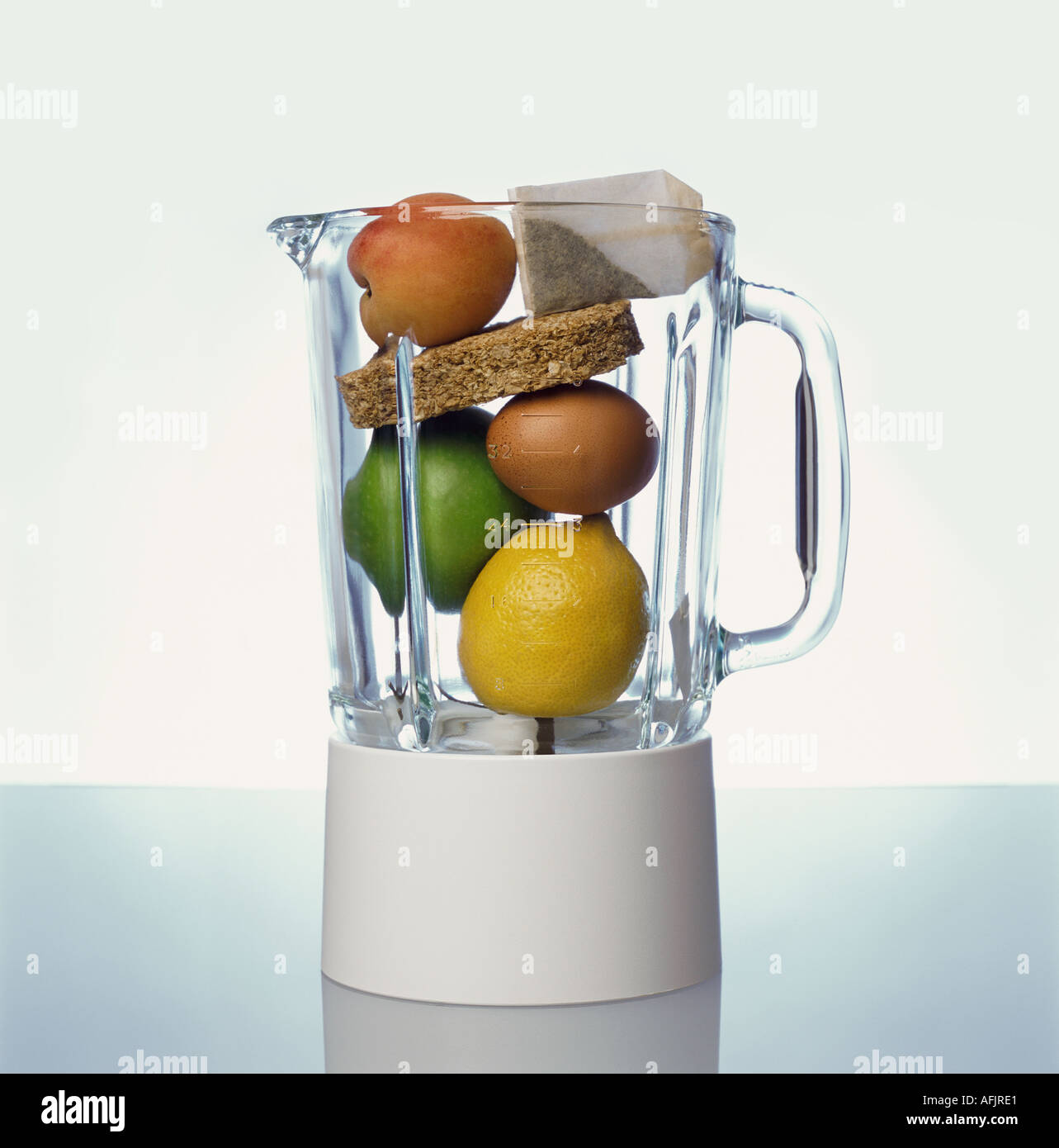 Blender containing tea bag apricot lemon lime egg wheat biscuit Stock Photo