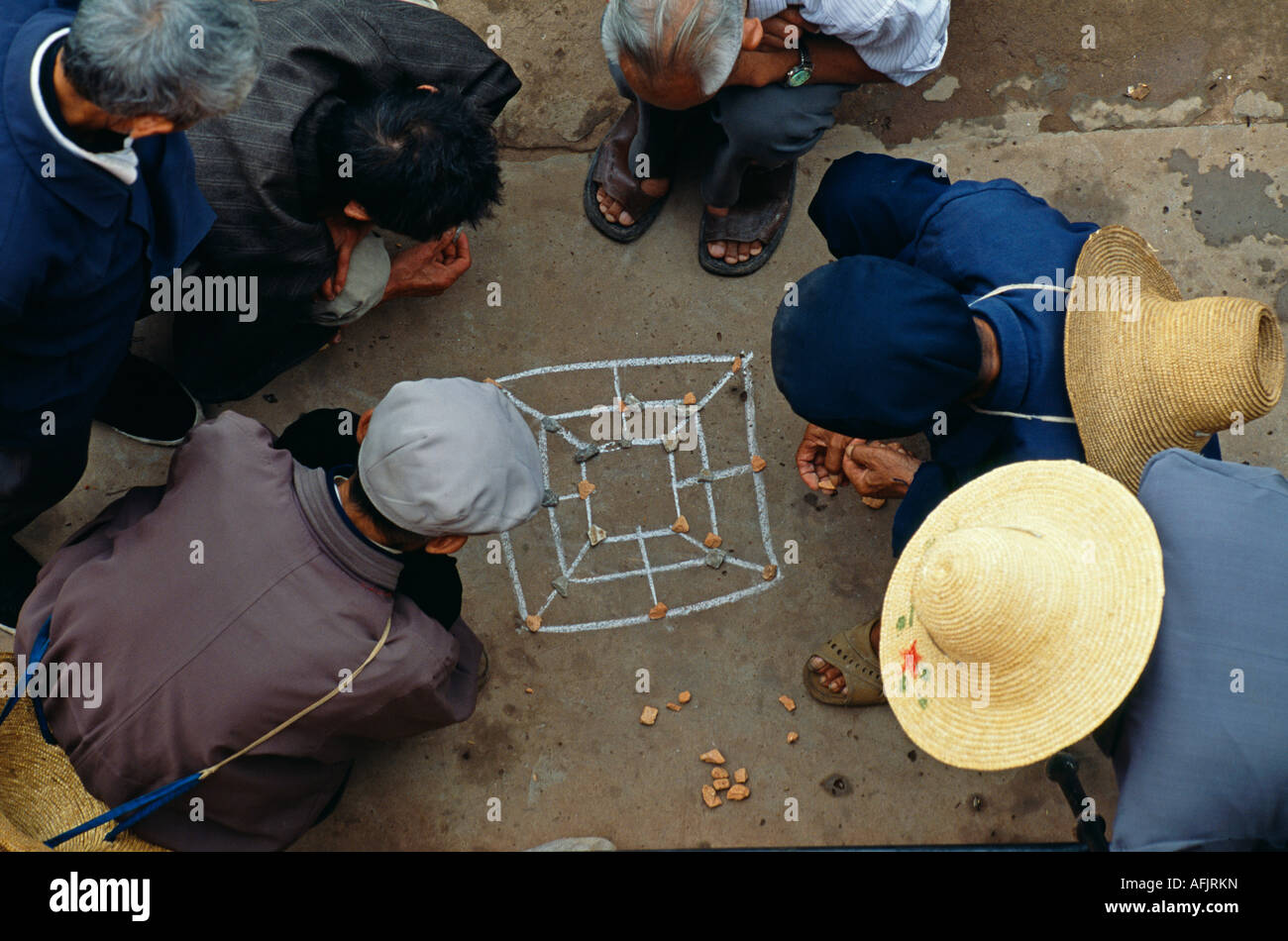 Townsfolk play an impromptu game on the pavement near Chaoyang Gate ...