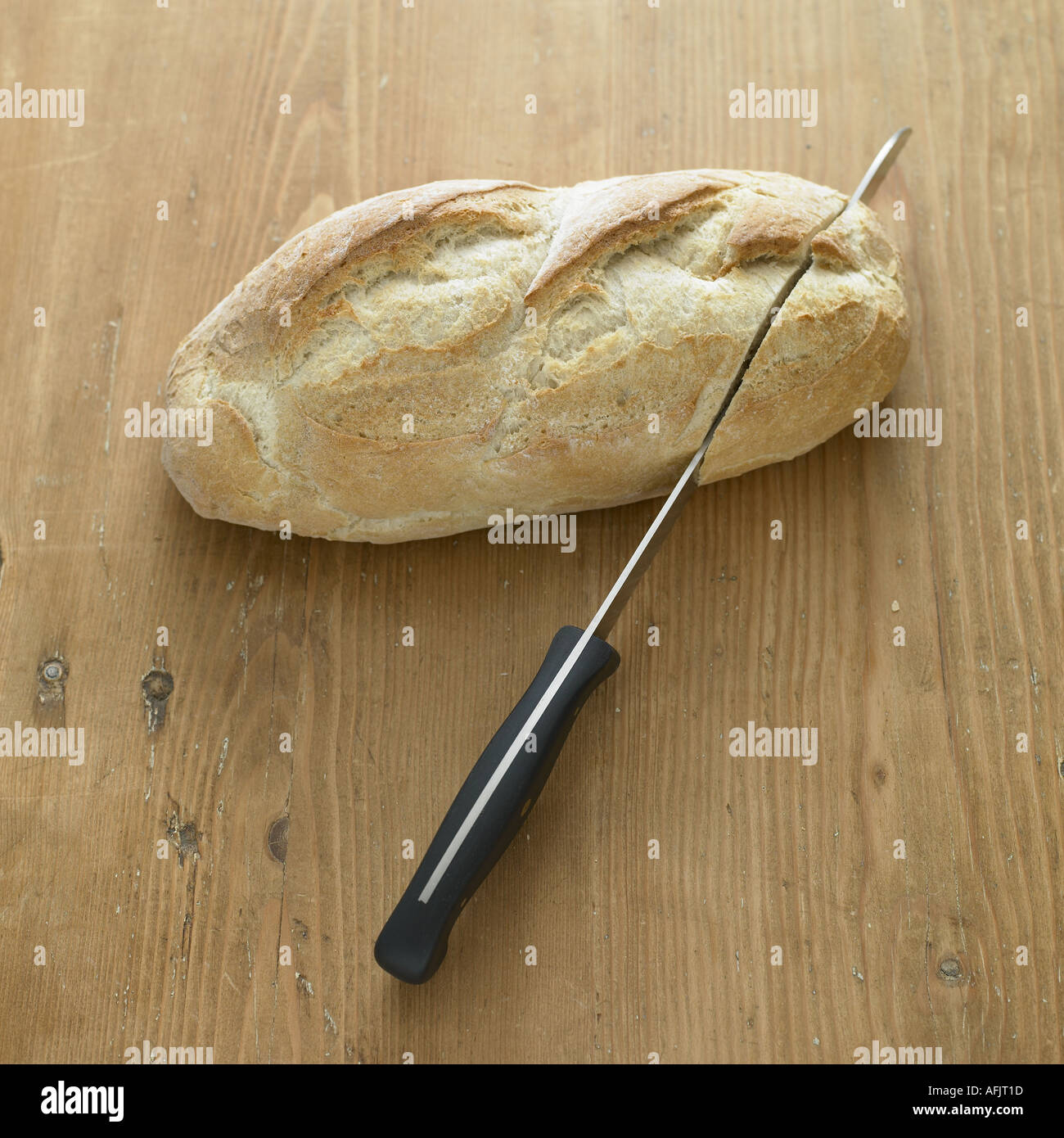 Loaf of white bread and knife Stock Photo