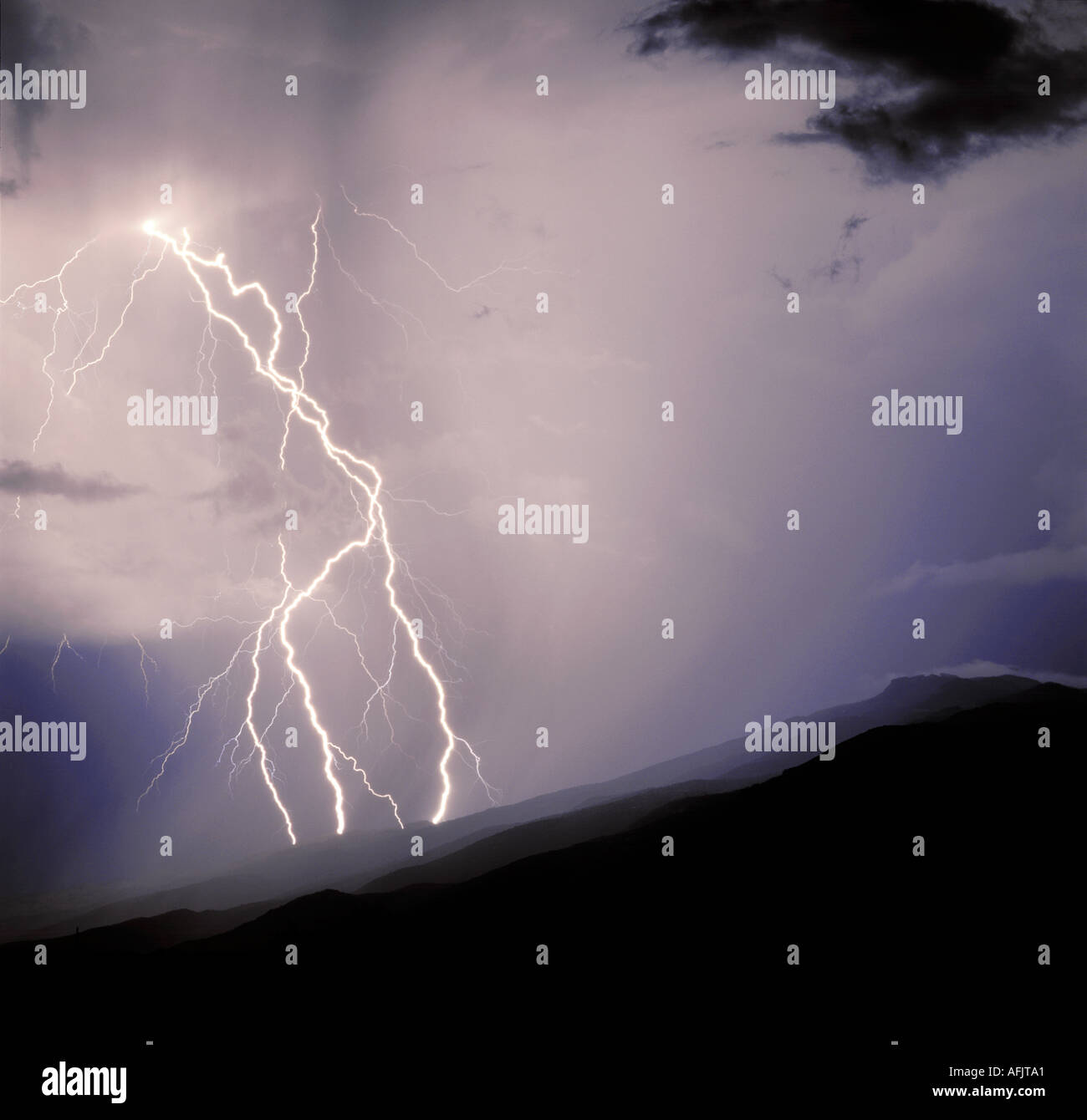 Lightning striking from storm clouds over the Rincon mountains outside of Tucson, Arizona, USA. Stock Photo