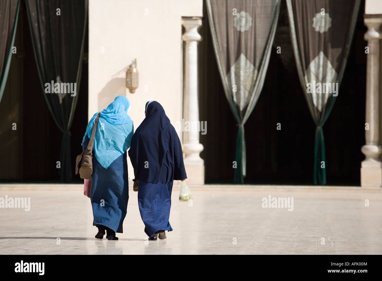 Two muslim women enter the AlHakim Mosque in Islamic Cairo. The mosque