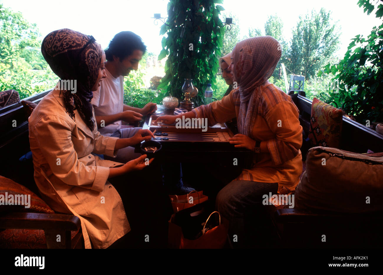 Young Turkish women in traditional dress play backgamon table game in Sultanahmet district Istanbul Turkey Stock Photo