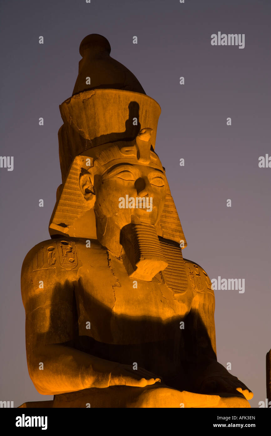 A larger than life statue of Ramses II illuminated at night in Luxor ...