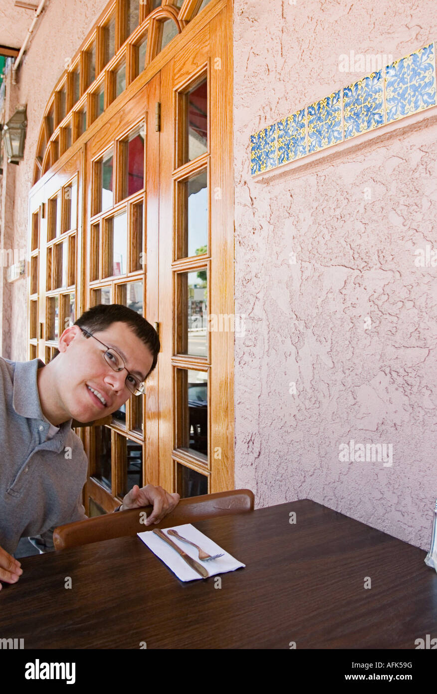 Man sitting at outdoor restaurant. Stock Photo