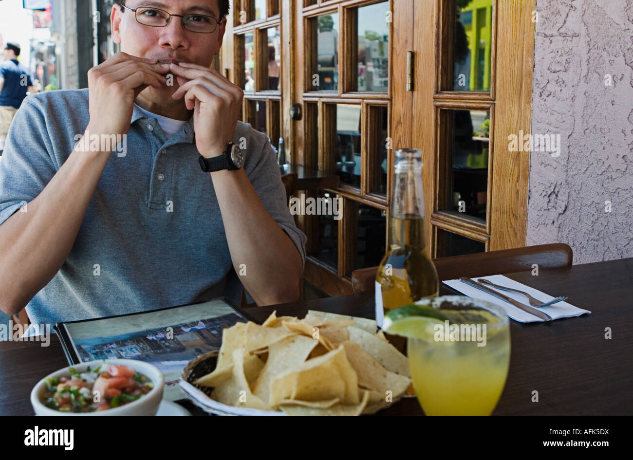Man eating at outdoor restaurant. Stock Photo