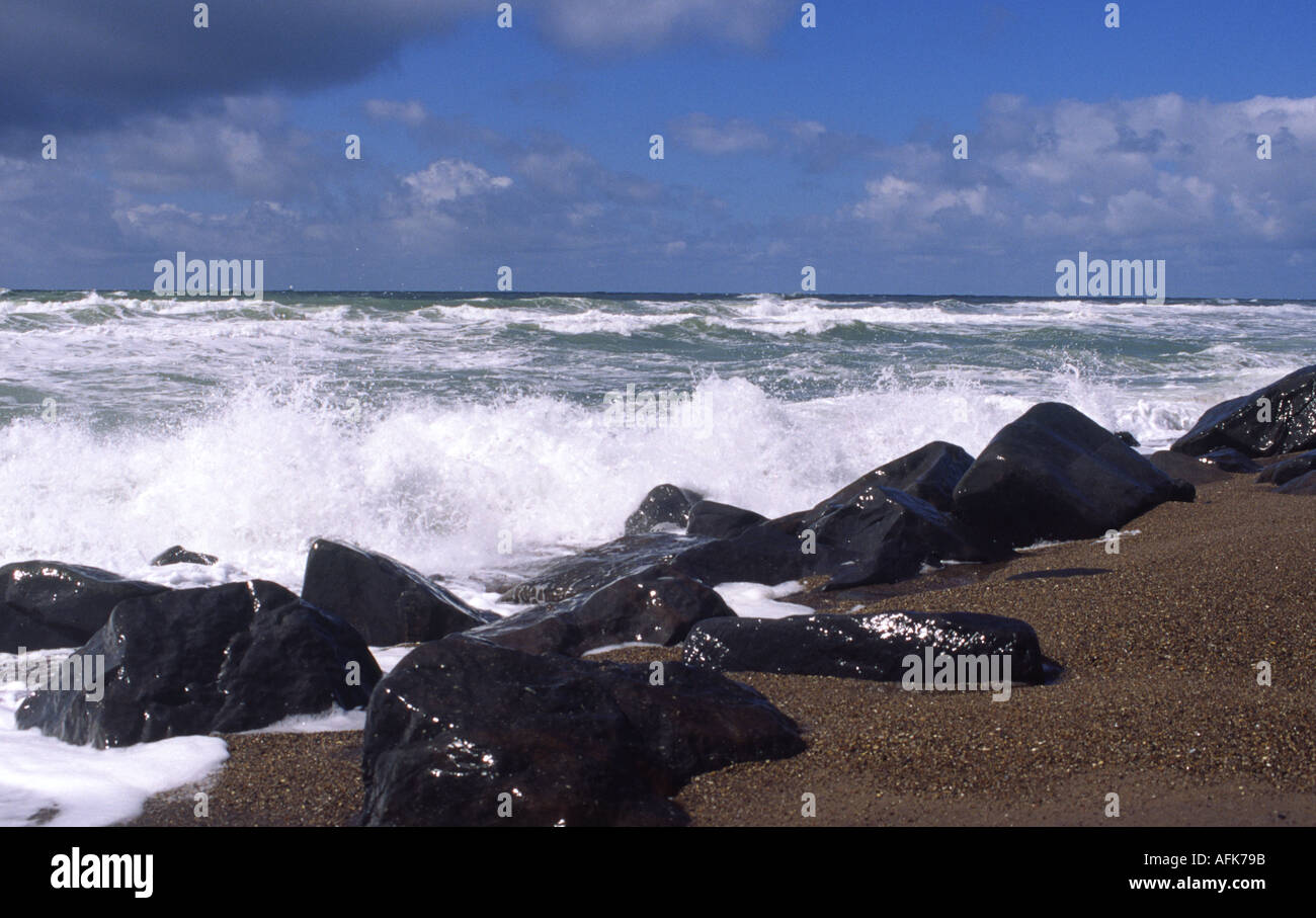 Waves crash on rocks on a windy day near Tyboron in West Jutland Stock Photo