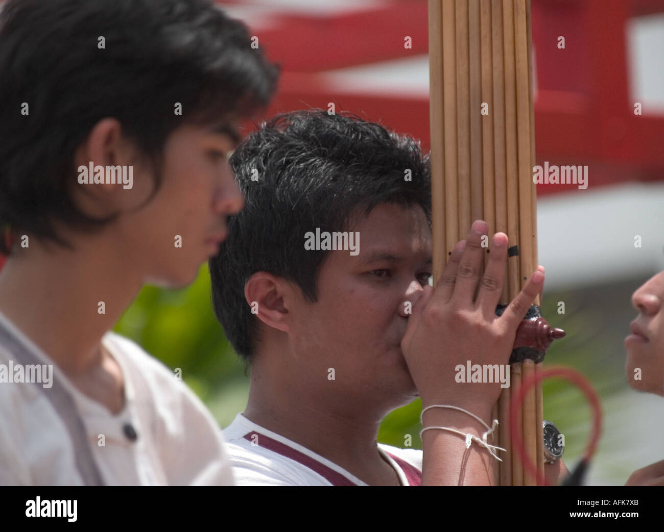 PERFORMERS IN LOCAL COSTUMES PLAY PIPE MUSIC TO PUBLIC AT KOTA KINABALU