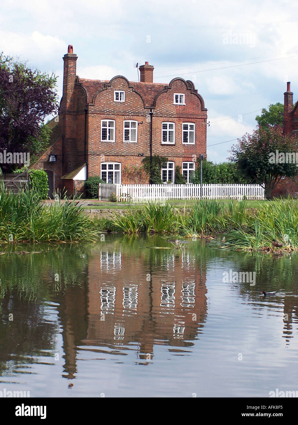 Old english house reflecting in a pond, Penn, Buckinghamshire