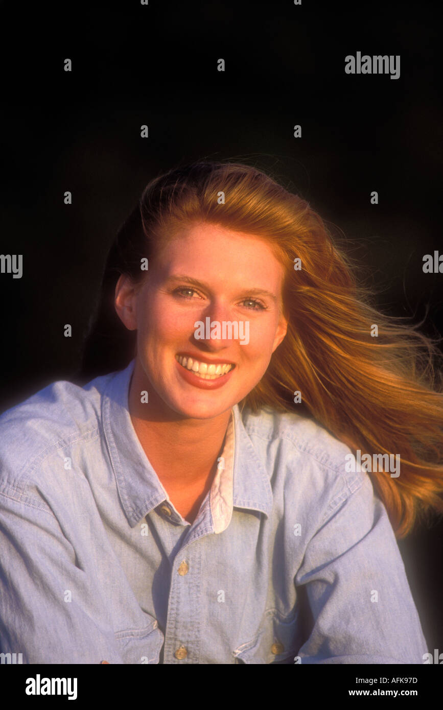 Portrait of smiling woman with red hair Model Released Image Stock Photo