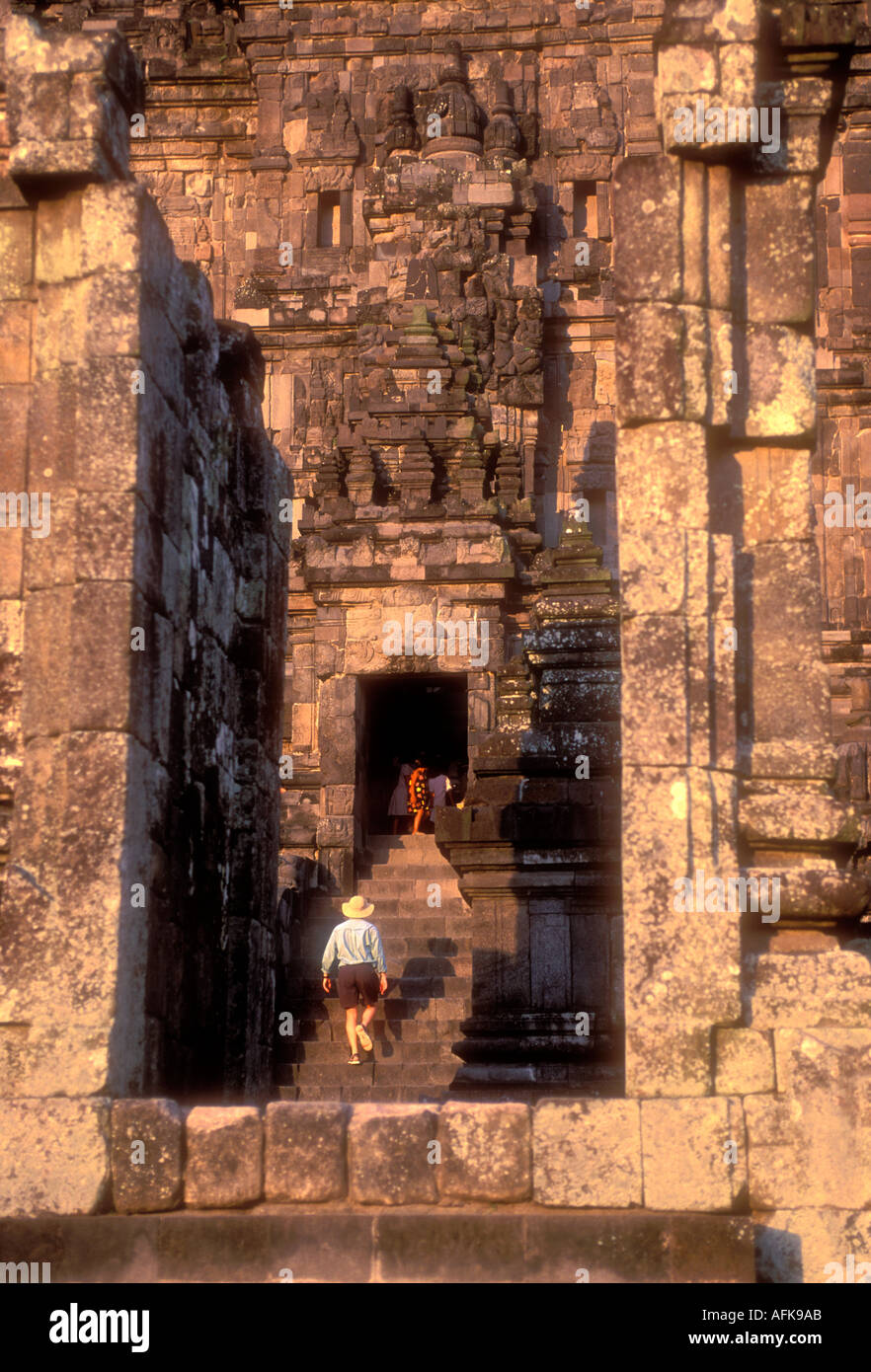 Man climbing stairs of large temple at Prambanan Java Indonesia Model Released Photo Stock Photo