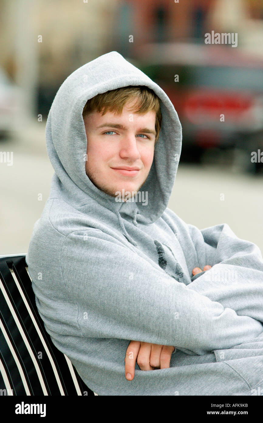 Portrait of teenage boy on park bench Stock Photo