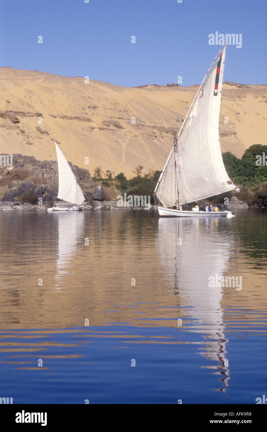 Two feluccas sailing towards each other on the River Nile near Aswan Egypt Stock Photo