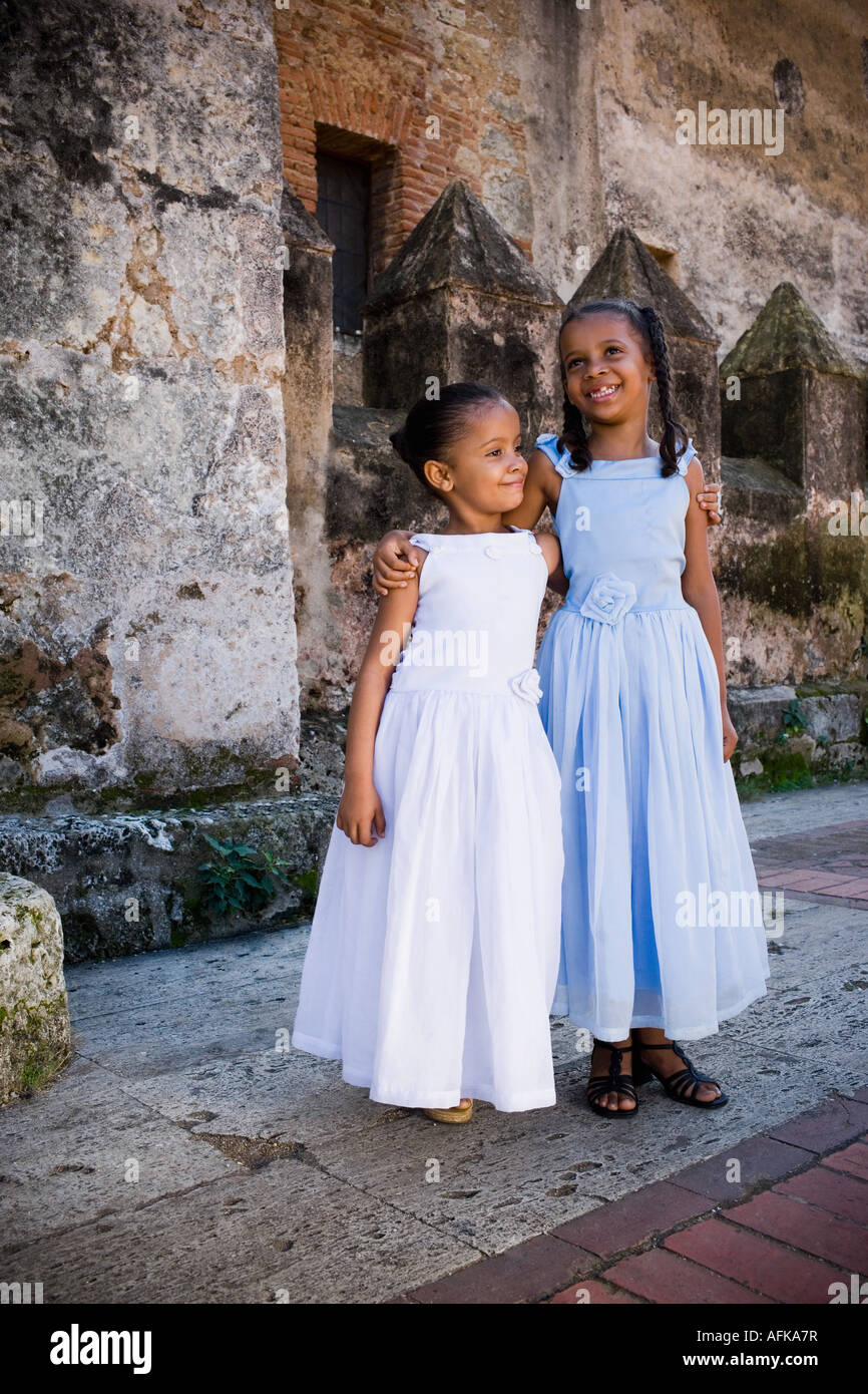 Two smiling girls with their arms around each other Stock Photo - Alamy