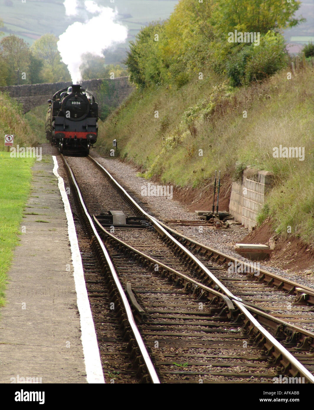 Steam train entering the Railway Station at Washford England UK 2004 Stock Photo