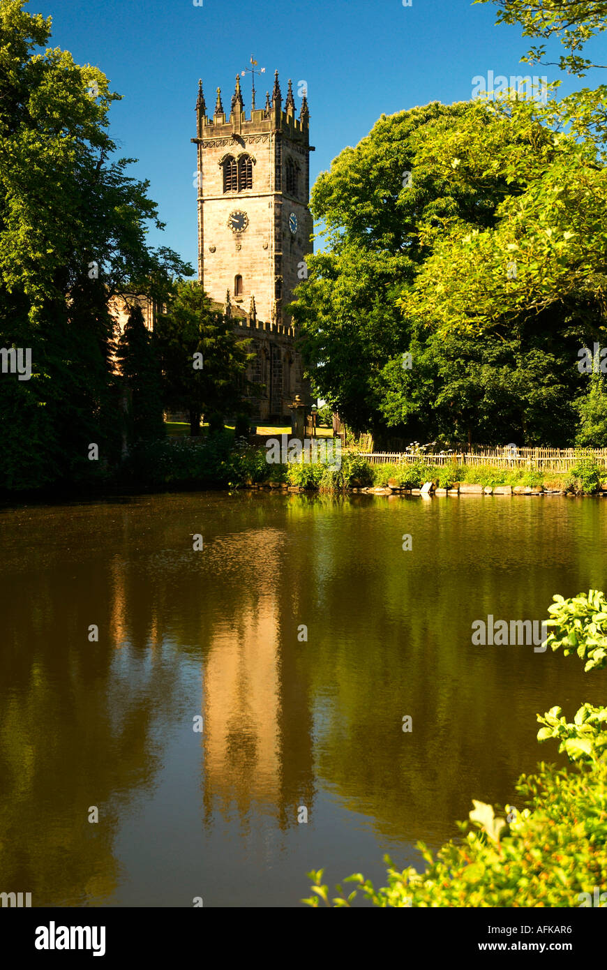 St James The Great Church Gawsworth Reflected in Pond Nr Macclesfield Cheshire UK Stock Photo