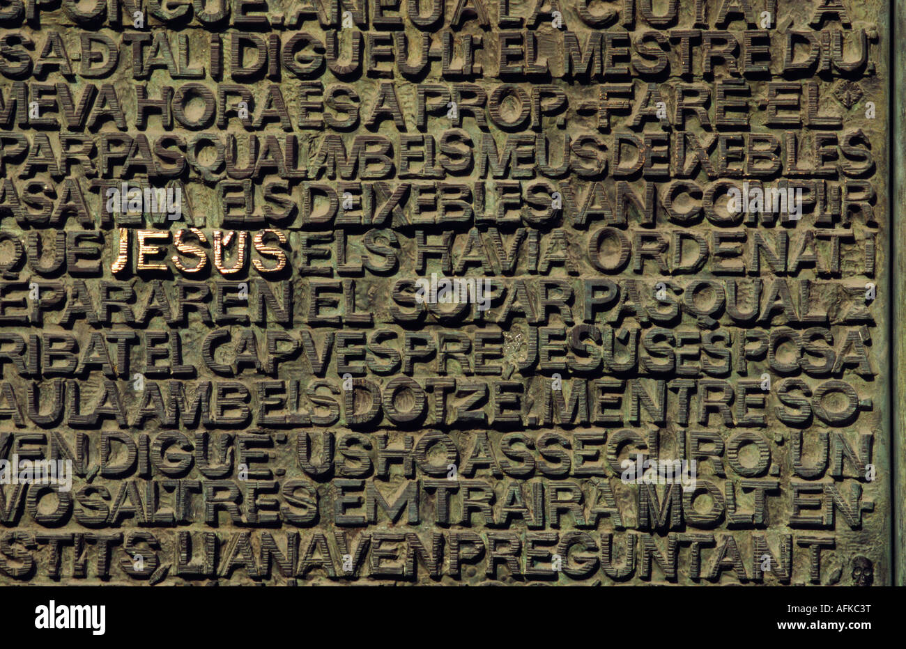 The name of Jesus stands out amidst a jumble of words etched into the door of the Passion Facade at Gaudi's La Sagrada Familia Stock Photo