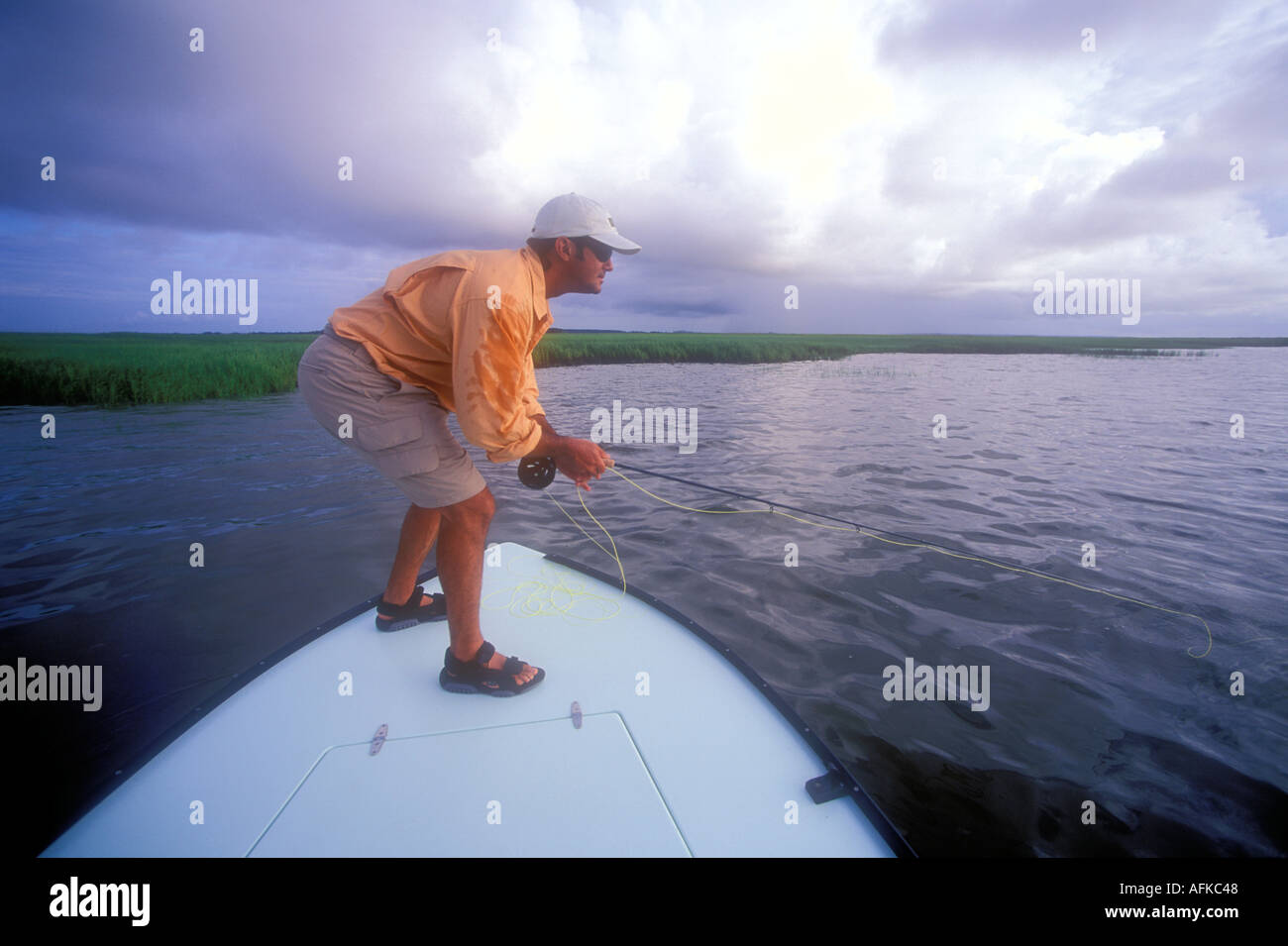Man fly fishing for redfish off bow of flats boat in Savannah