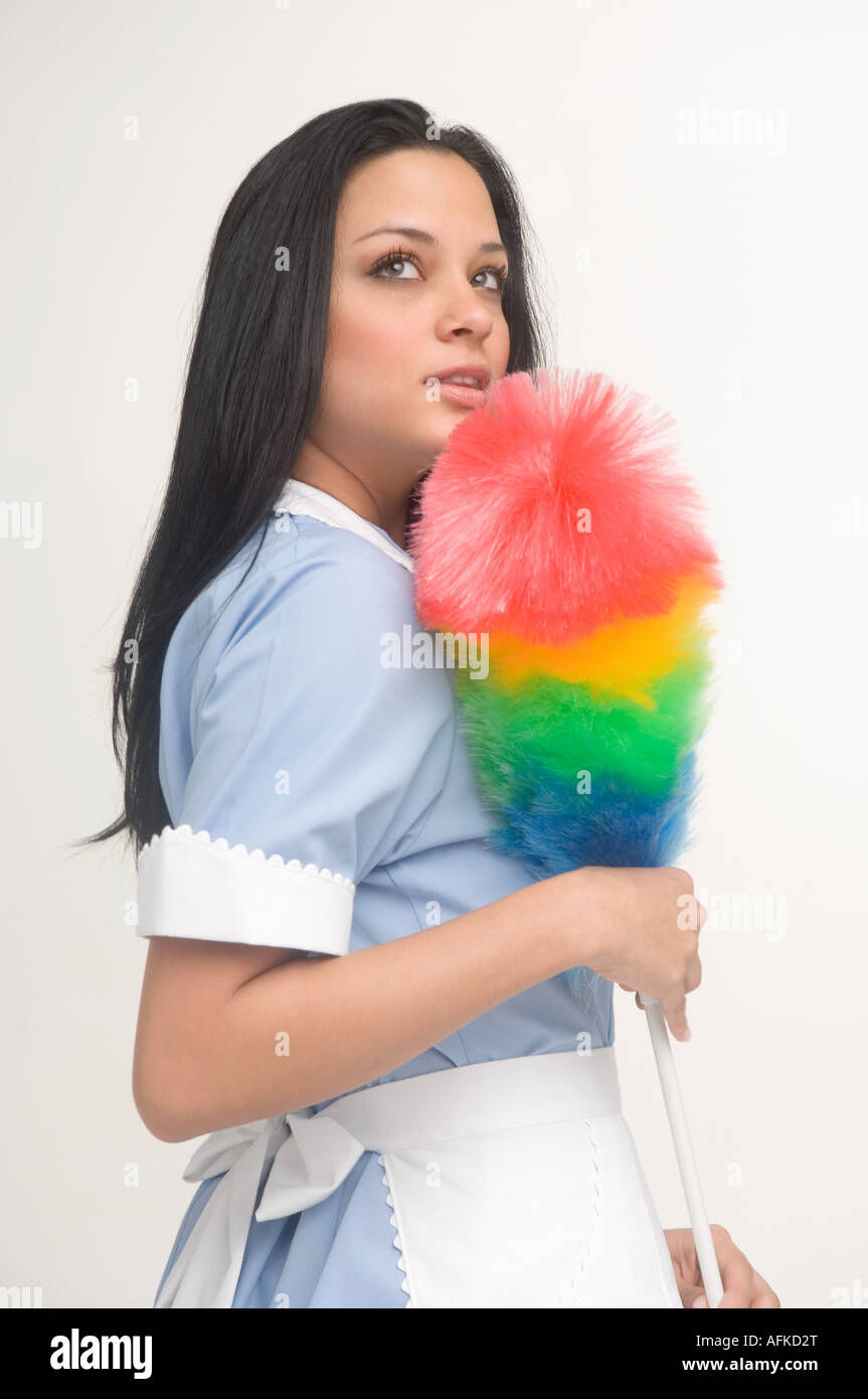 Maid holding feather duster Stock Photo Alamy