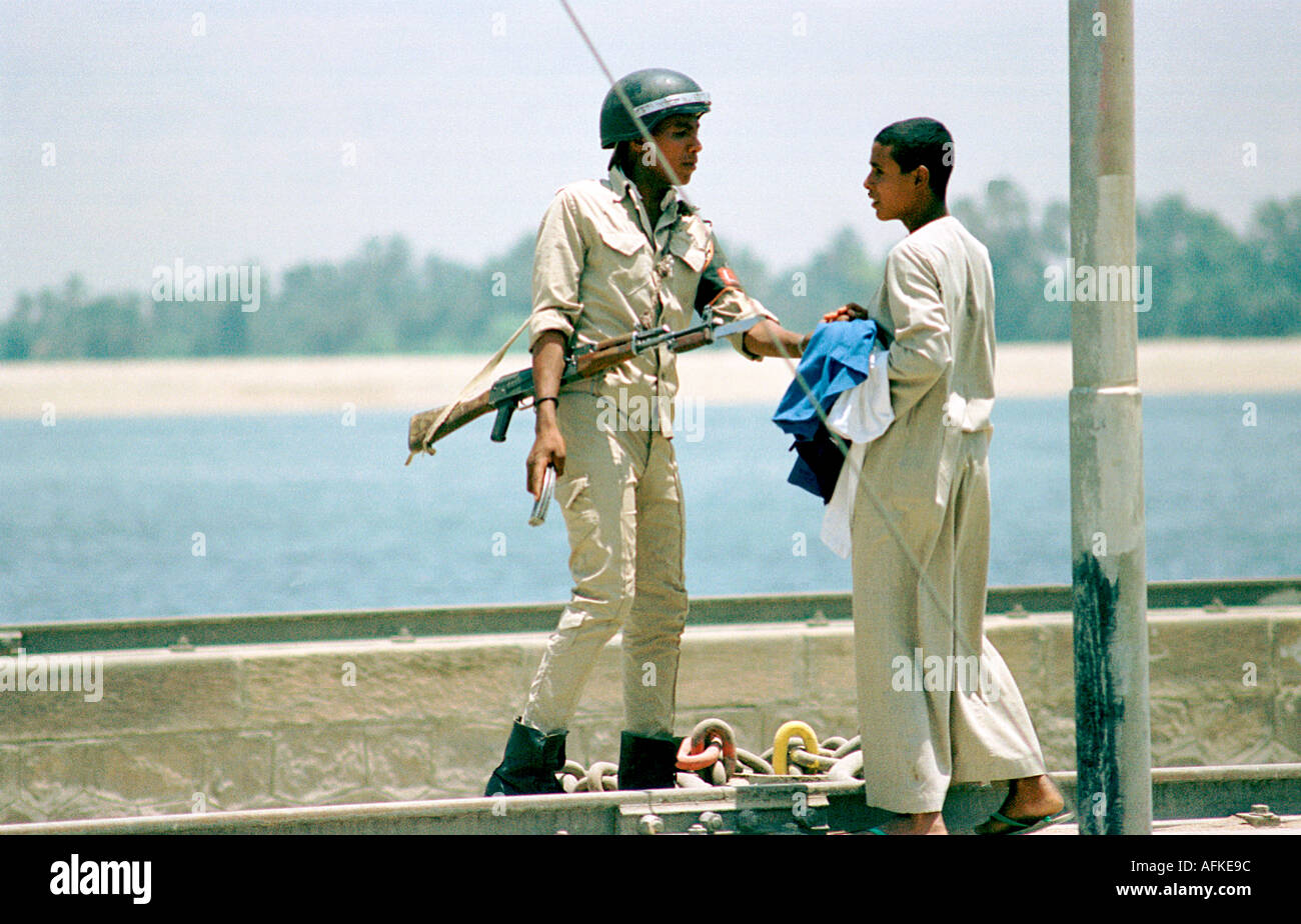 An Egyptian policeman going about his duty on the Aswan Dam Egypt Stock Photo