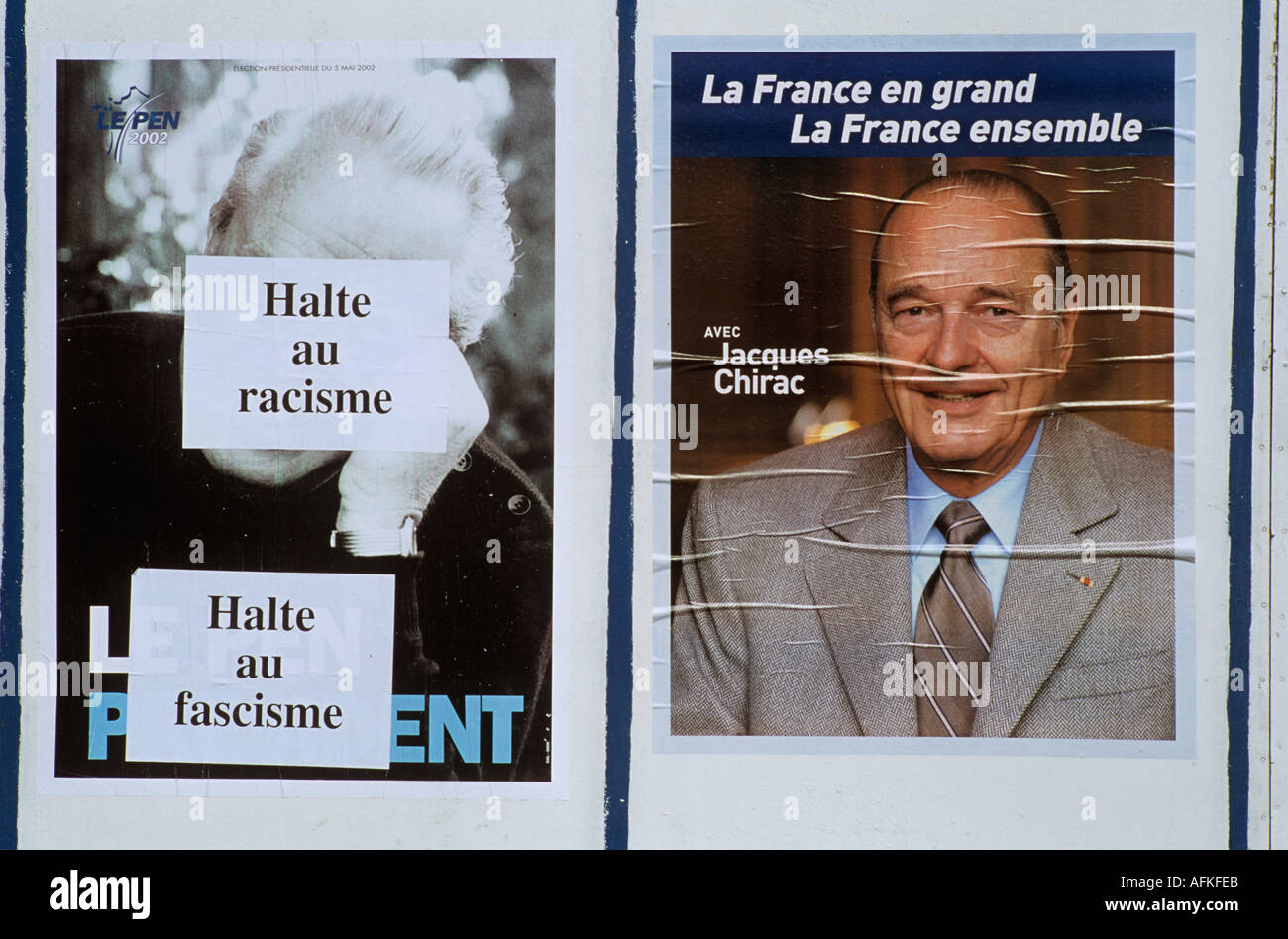 A defaced Jean Marie Le Pen poster alongside a poster for Jacques Chirac during the French Presidential Election of 2002 Stock Photo