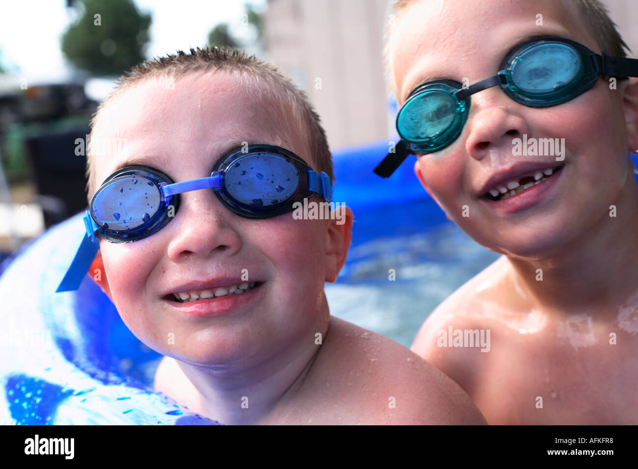 Boys in pool with swimming goggles Stock Photo Alamy