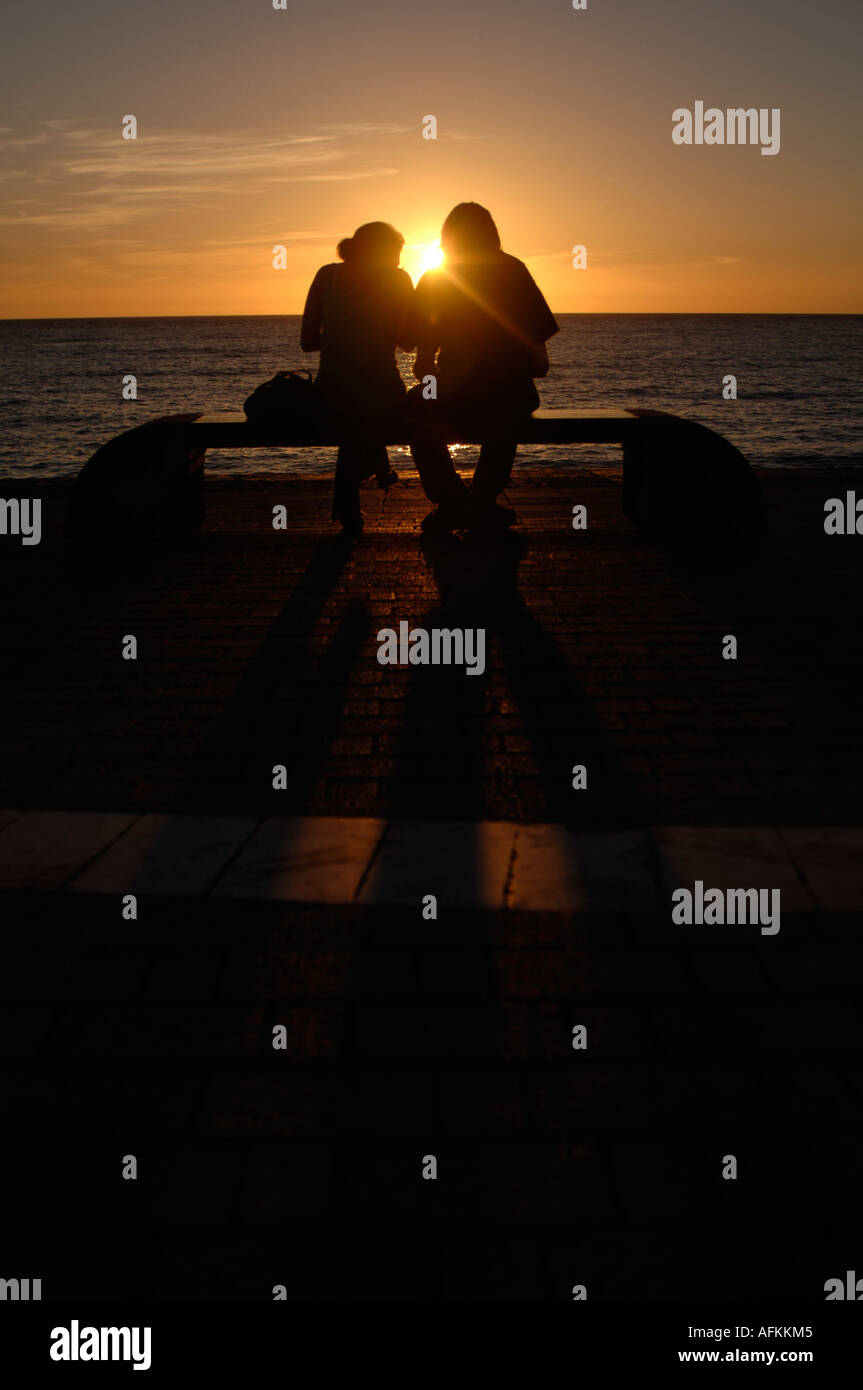 A young couple at sunset, promenade Aberystwyth Ceredigion Wales Cymru Stock Photo