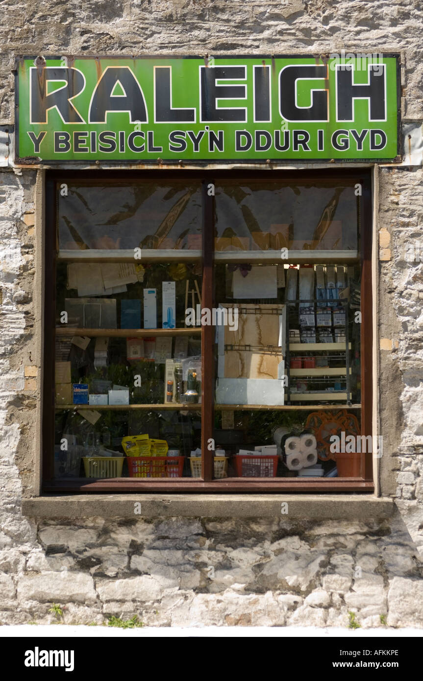 Raleigh bike shop sign in welsh (Y beisicl syn ddur i gyd / the bike that's all steel) Llandysul Ceredigion Wales Cymru Stock Photo