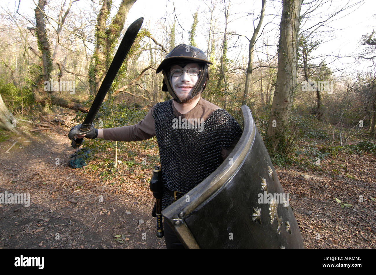 University student holding sword and shield in role playing games Penglais woods Aberystwyth Ceredigion wales UK Stock Photo