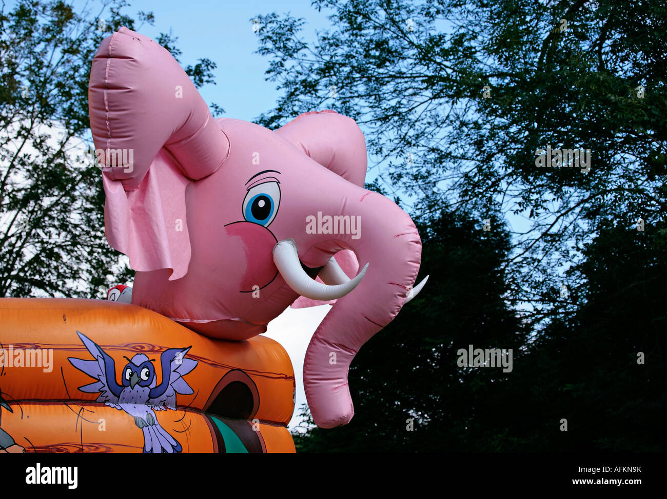 Large pink plastic inflatable elephant on Noah's Ark bouncy castle Stock Photo