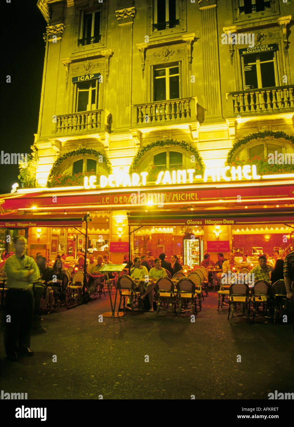 A restaurant at night along the Seine River near the Eiffel Tower in the heart of Paris France