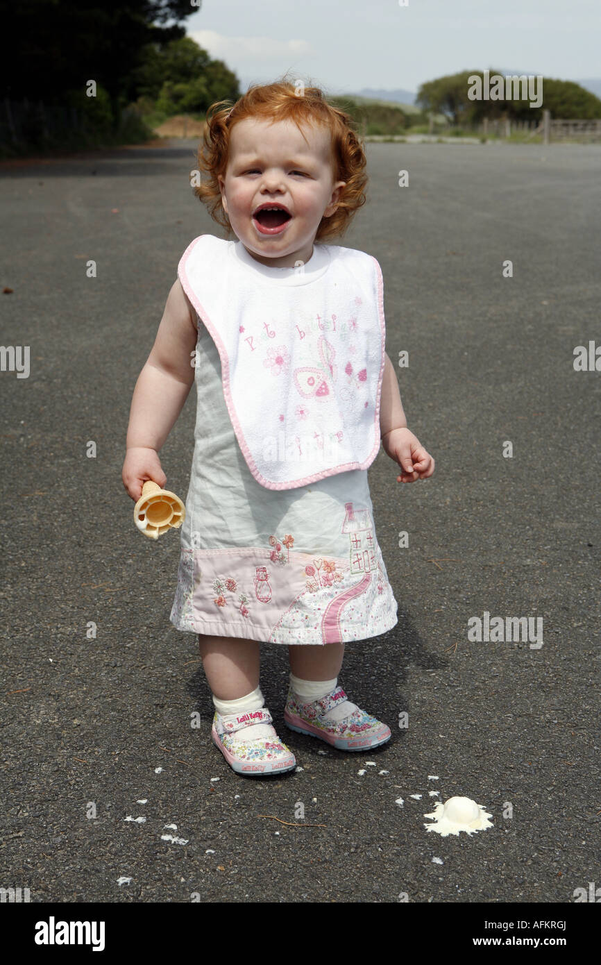 Little girl with her ice cream that has dropped on the floor Stock