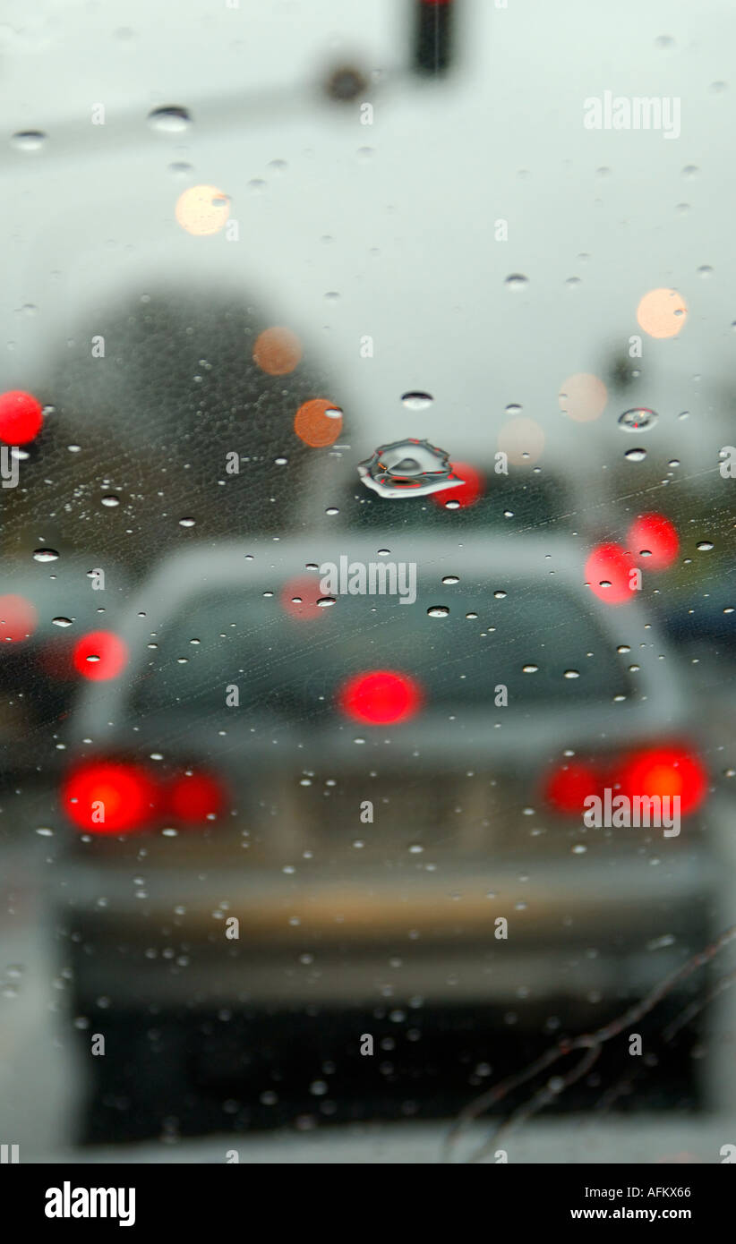 Car brake lights through a rain splashed windscreeen Stock Photo Alamy