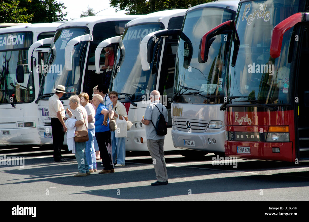Elderly people waiting in coach park at Bourton on the Water Gloucestershire England UK Stock Photo