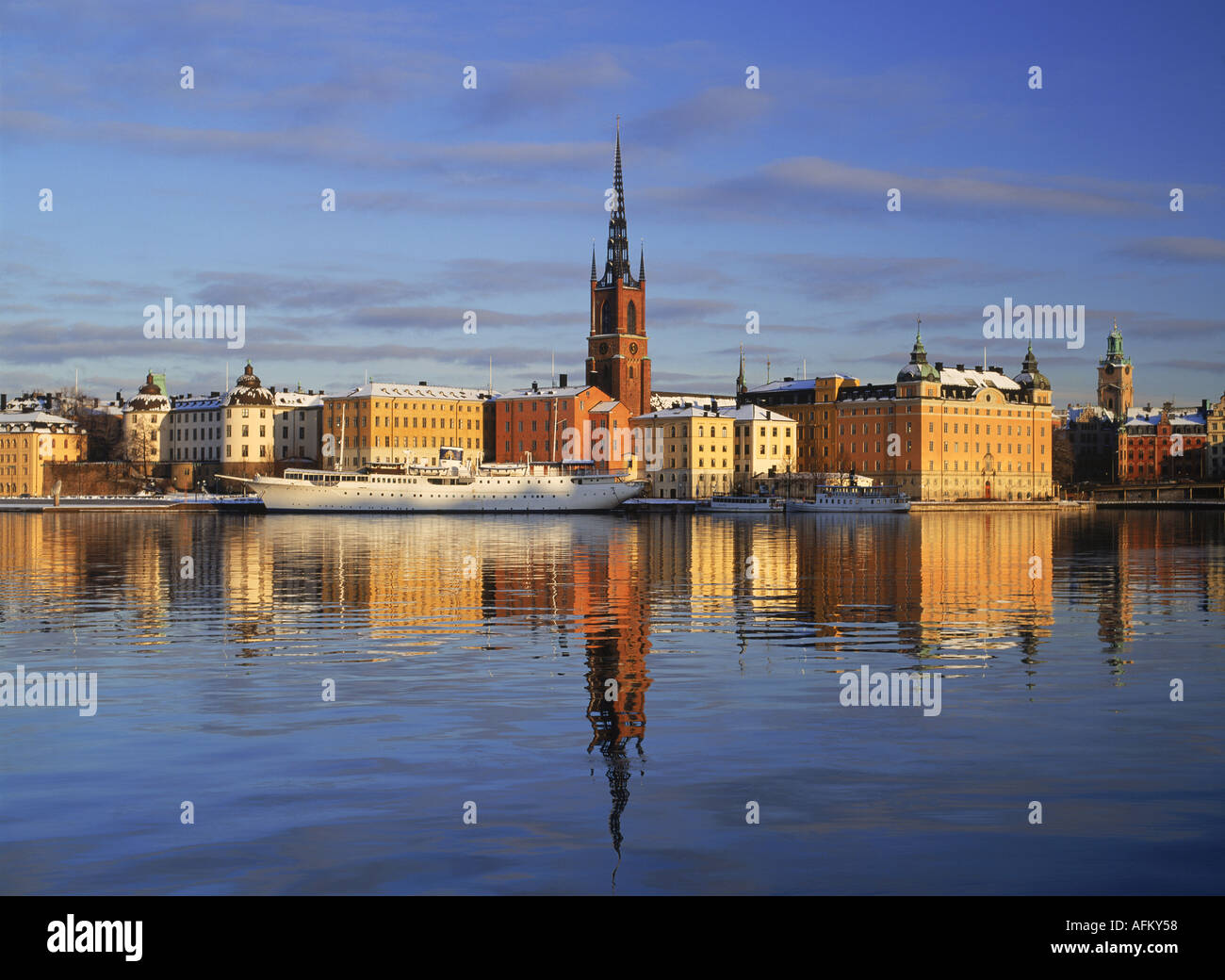 Church steeple in Old Town and Riddarholmen Island reflecting off Riddarfjarden in Stockholm in winter Stock Photo