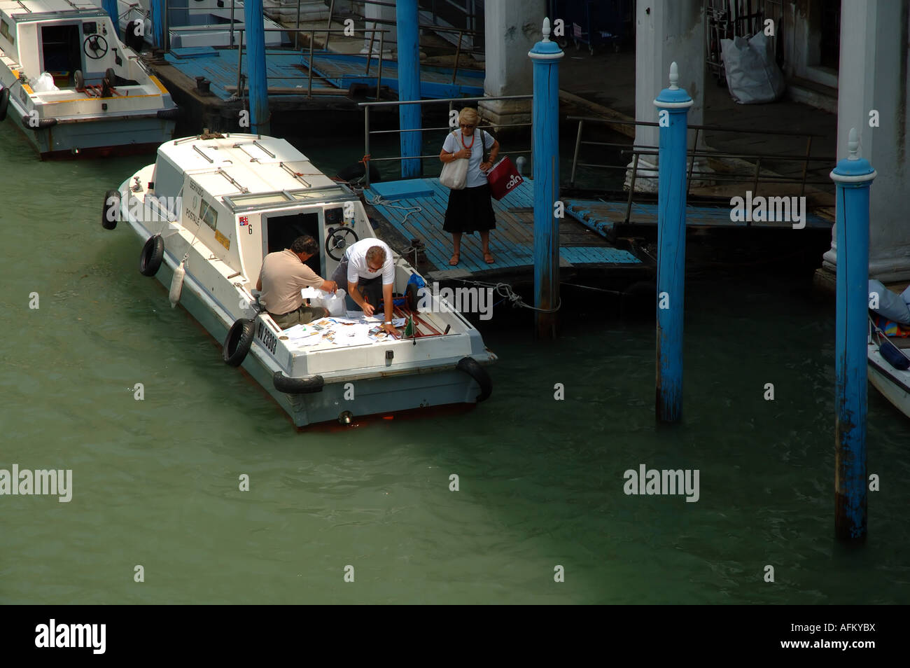 Sorting mail on the back of the postal service boat Servizio Postale in ...