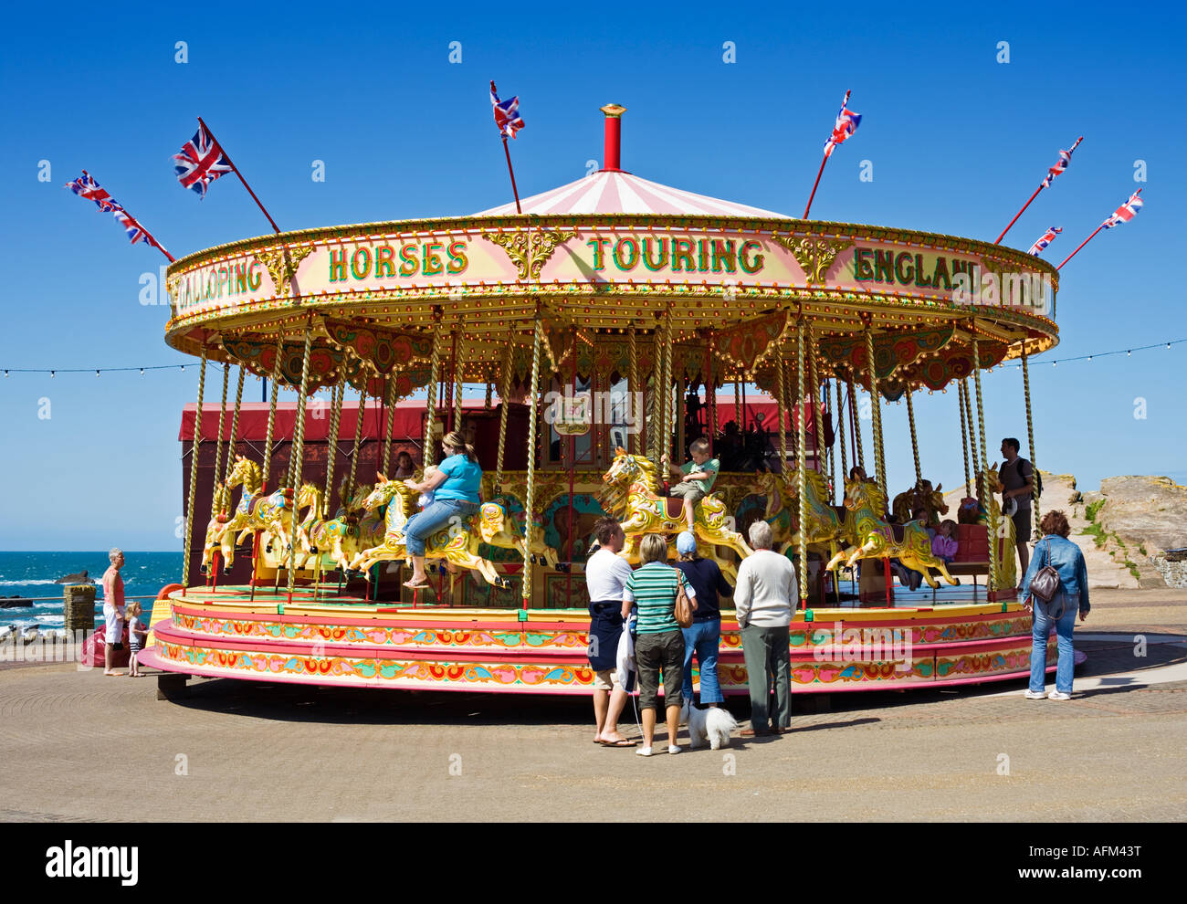 Ilfracombe, Devon UK - merry go round fairground carousel ride on the promenade Stock Photo