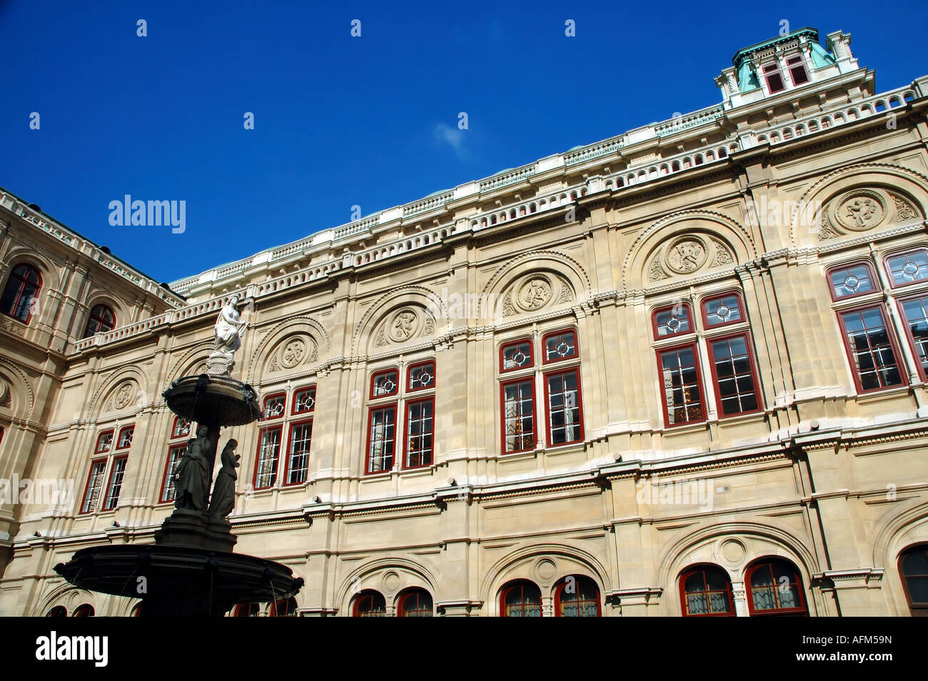 Fountain and side view of the magnificent Opera House Staatsoper in central Vienna Austria Stock Photo