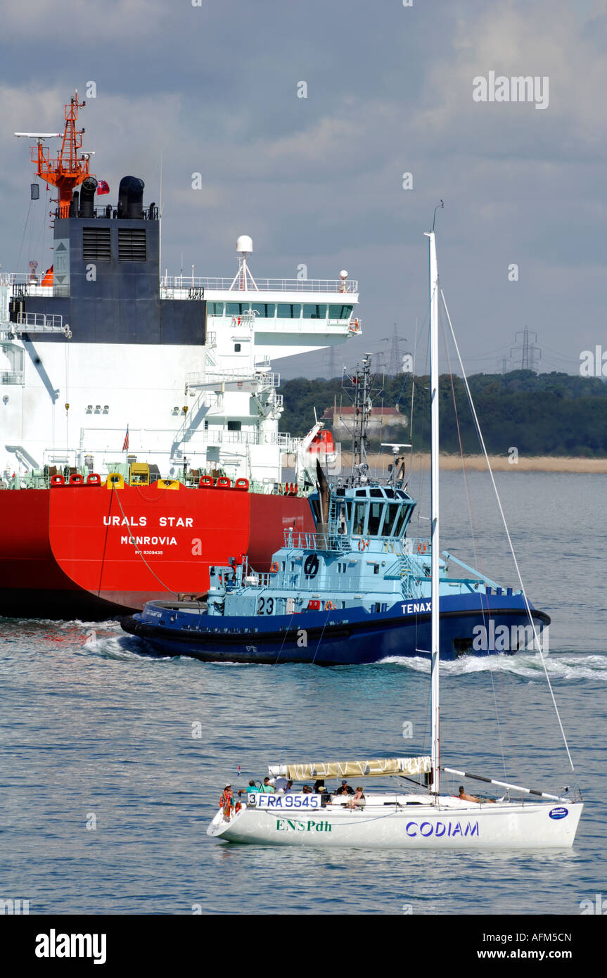 busy shipping in the thorn channel exclusion area zon in the solent off of cowes on the isle of wight showing a tug tanker yacht Stock Photo